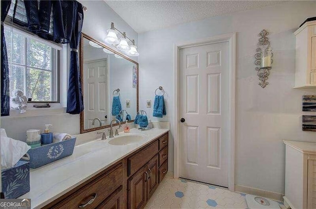 bathroom with vanity and a textured ceiling