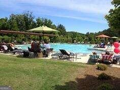 view of pool featuring a lawn