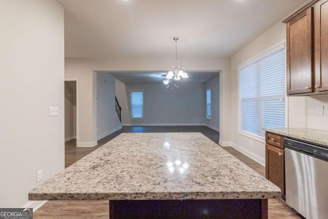 kitchen featuring a chandelier, dishwasher, a center island, and pendant lighting