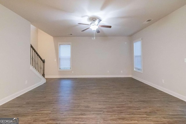 unfurnished room featuring ceiling fan and dark wood-type flooring