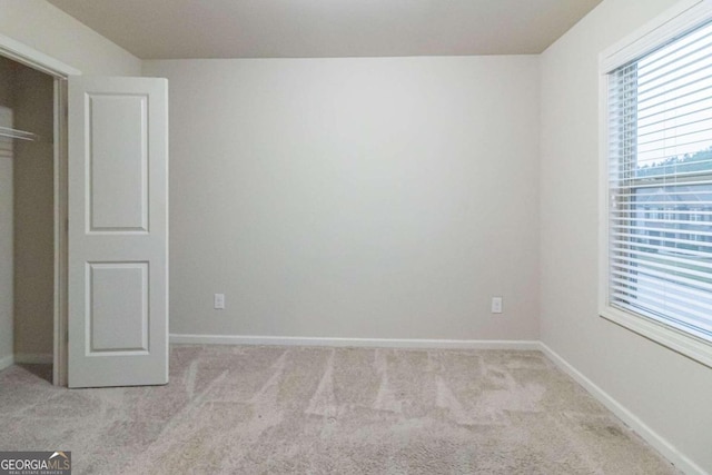 unfurnished bedroom with light carpet