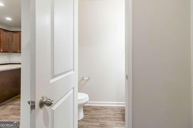 bathroom with wood-type flooring and toilet