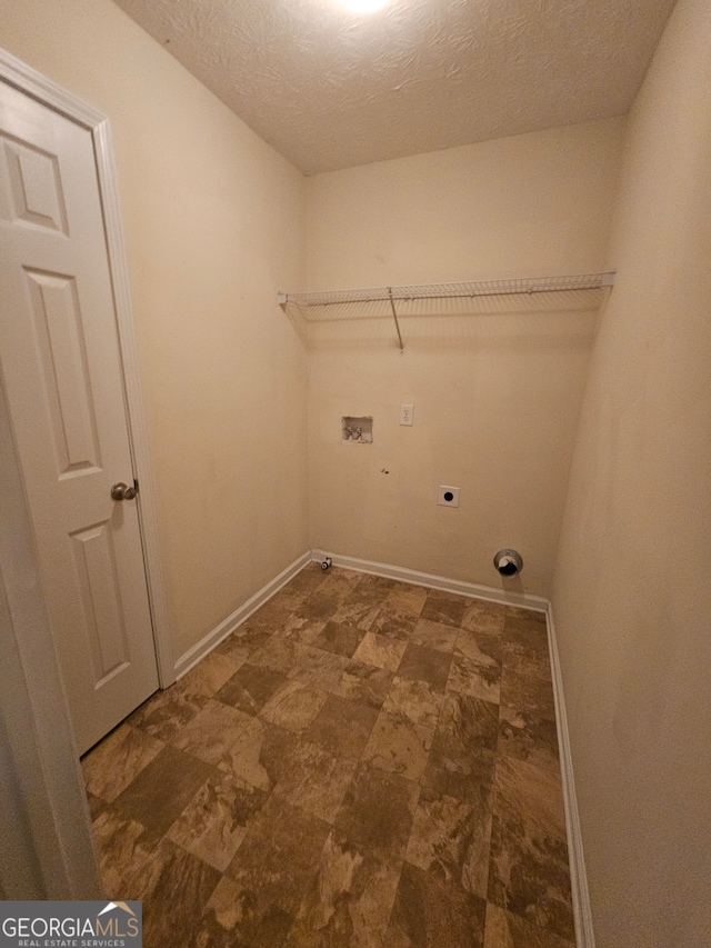 washroom featuring washer hookup, a textured ceiling, and hookup for an electric dryer