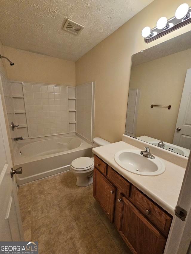 full bathroom featuring vanity, toilet, a textured ceiling, and shower / washtub combination