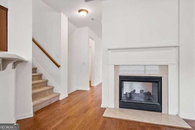 interior details with hardwood / wood-style flooring and a multi sided fireplace