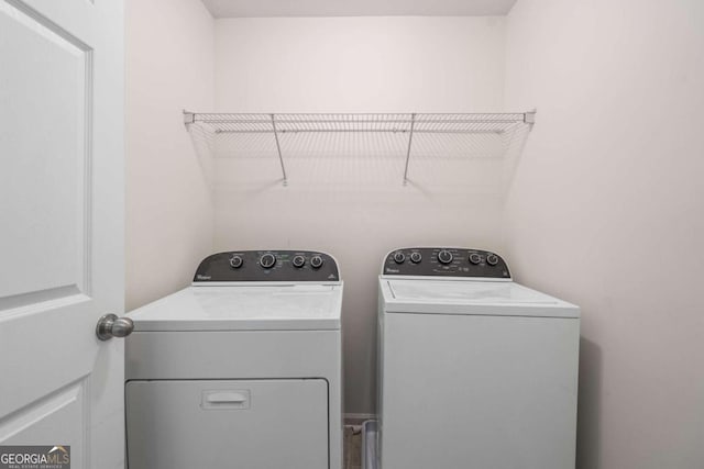 laundry room with washing machine and clothes dryer