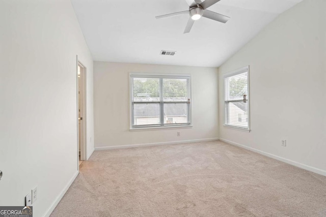 carpeted empty room with ceiling fan and lofted ceiling