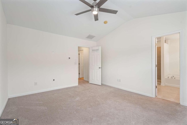 unfurnished bedroom featuring ceiling fan, light colored carpet, lofted ceiling, and connected bathroom