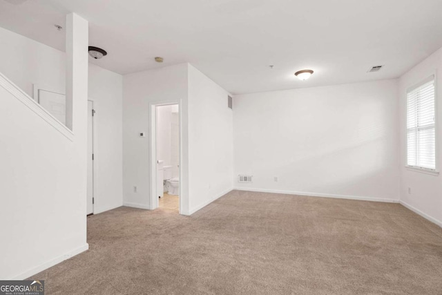 unfurnished room with light carpet