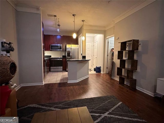 kitchen featuring a center island, crown molding, light hardwood / wood-style floors, decorative light fixtures, and appliances with stainless steel finishes