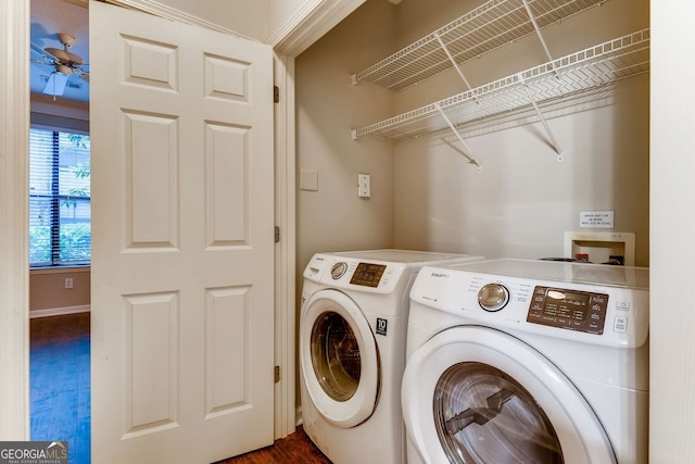 washroom featuring dark hardwood / wood-style flooring and washing machine and clothes dryer