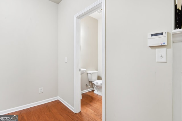 bathroom with wood-type flooring and toilet