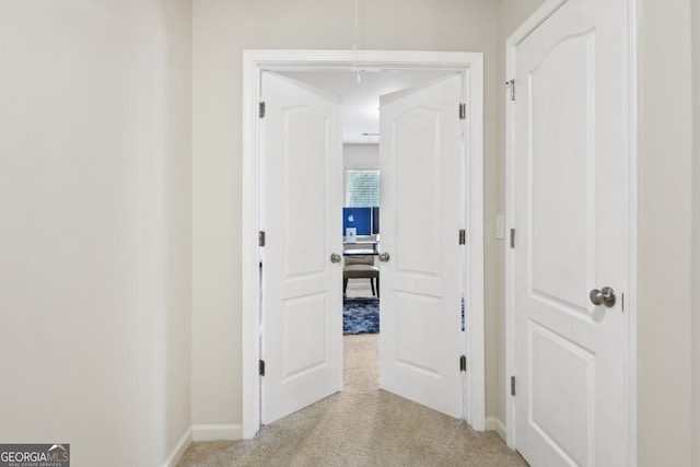 hallway with light colored carpet