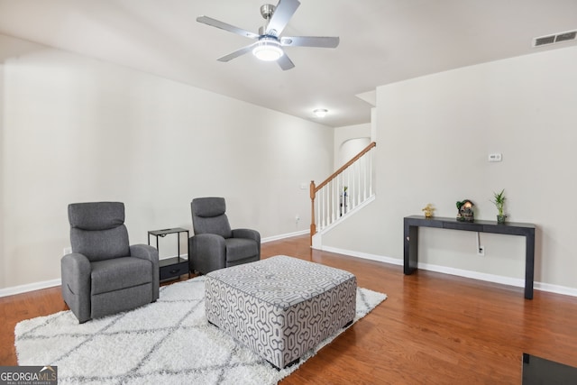 living room with ceiling fan and hardwood / wood-style floors