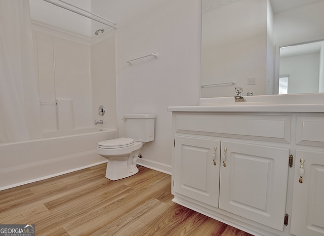 full bathroom featuring bathing tub / shower combination, hardwood / wood-style floors, vanity, and toilet