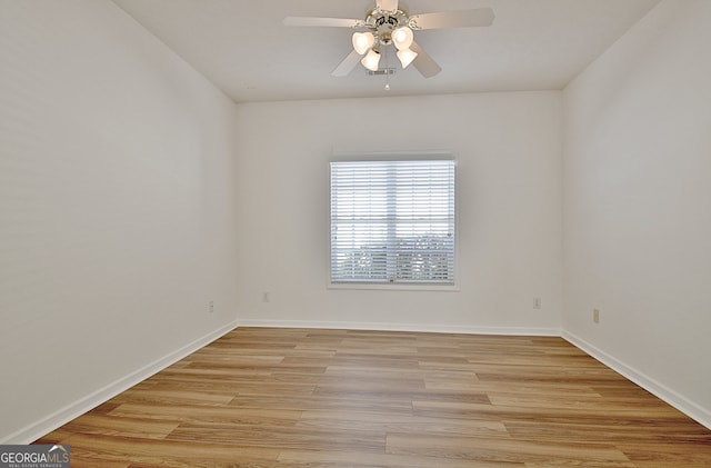 spare room with ceiling fan and light wood-type flooring