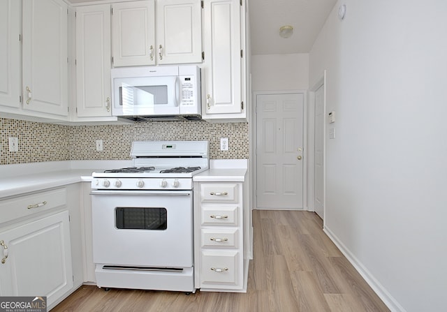 kitchen featuring decorative backsplash, white cabinetry, white appliances, and light hardwood / wood-style flooring