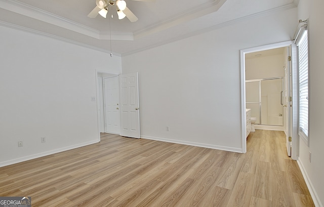 unfurnished bedroom with light hardwood / wood-style floors, a raised ceiling, ceiling fan, and ornamental molding