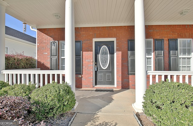 doorway to property featuring covered porch