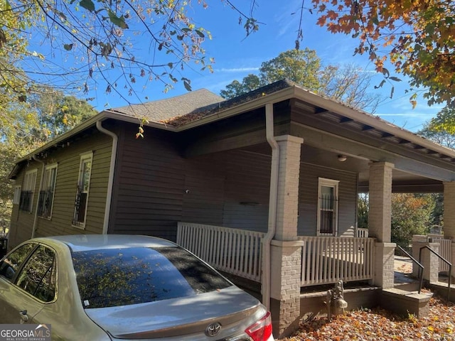 view of side of home with covered porch