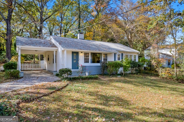 ranch-style house with a front yard and a carport