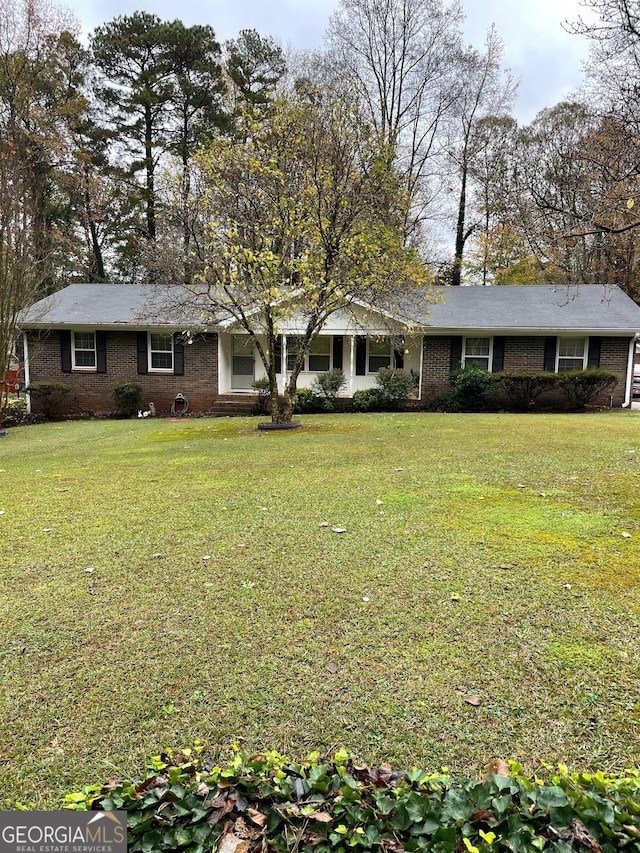 ranch-style house with a front lawn