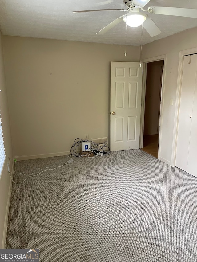 unfurnished bedroom with carpet and ceiling fan