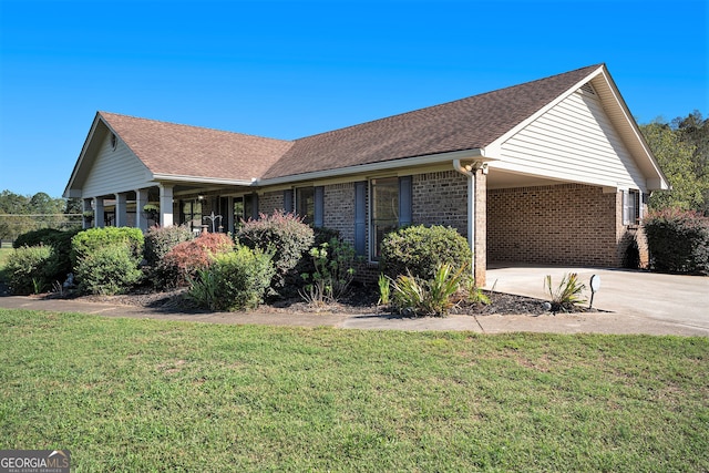 single story home featuring a front lawn and a carport