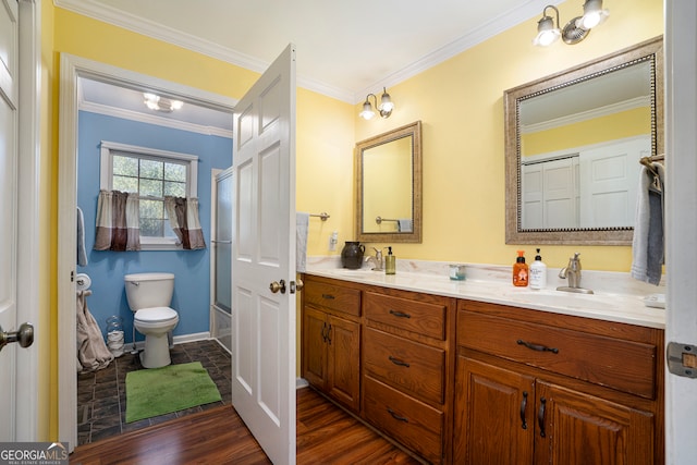 full bathroom with combined bath / shower with glass door, ornamental molding, vanity, wood-type flooring, and toilet