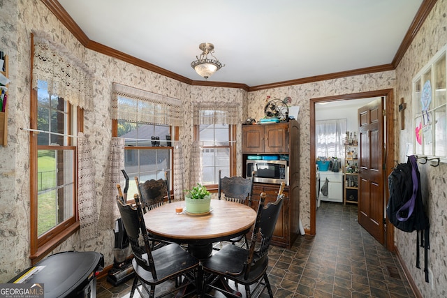 dining space featuring crown molding