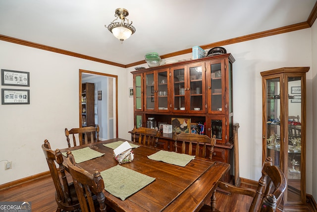 dining area with crown molding and dark hardwood / wood-style floors