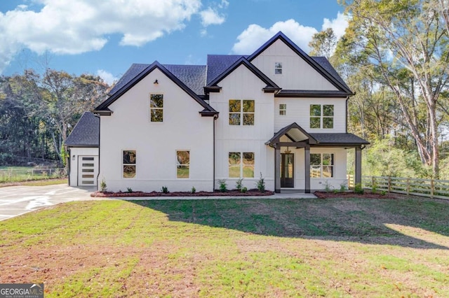 view of front of home featuring a front yard and a garage