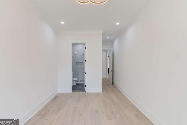 hall featuring light hardwood / wood-style floors and ornamental molding