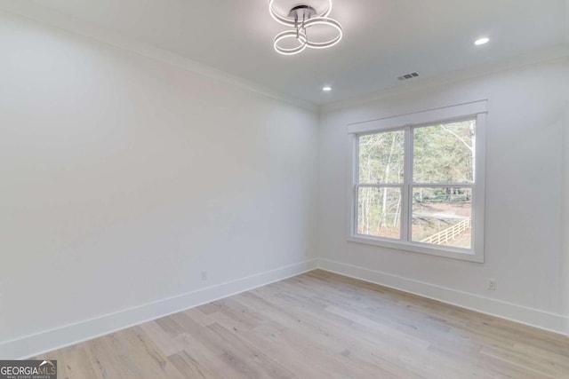 unfurnished room with light wood-type flooring and crown molding