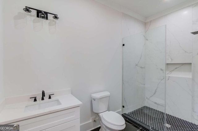 bathroom with vanity, toilet, and a tile shower