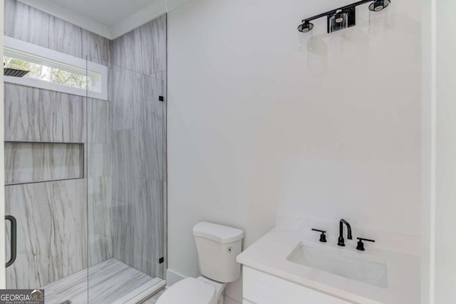 bathroom featuring vanity, an enclosed shower, and toilet