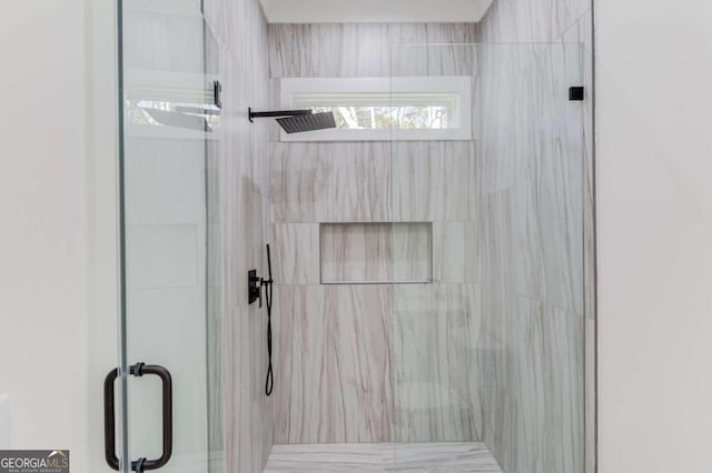 bathroom featuring a shower with door