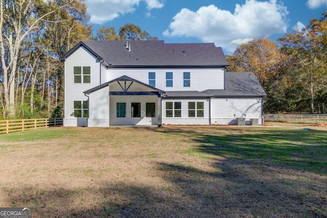 back of property featuring a lawn