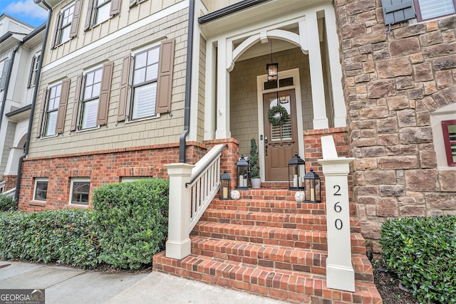 doorway to property with brick siding