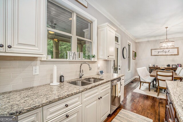 kitchen with dark hardwood / wood-style flooring, light stone countertops, sink, and white cabinets