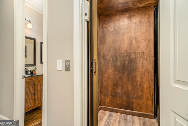 bathroom with hardwood / wood-style flooring, vanity, and elevator