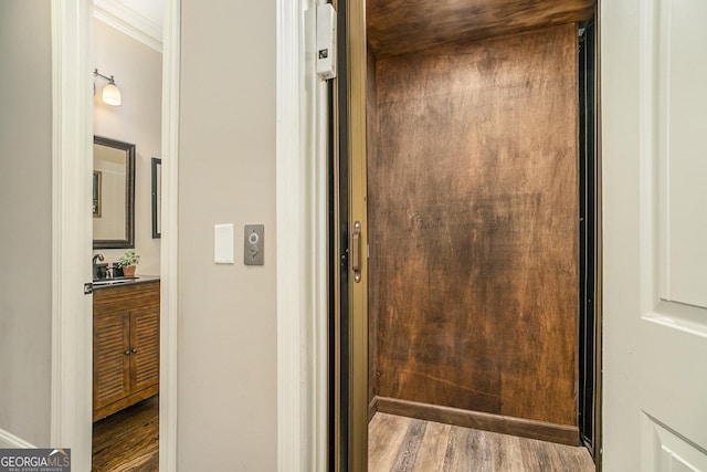 doorway to property with elevator and a sink