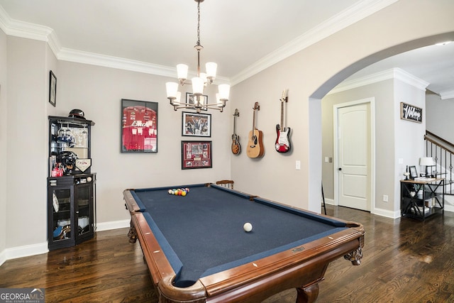 recreation room with baseboards, arched walkways, dark wood-style flooring, and ornamental molding