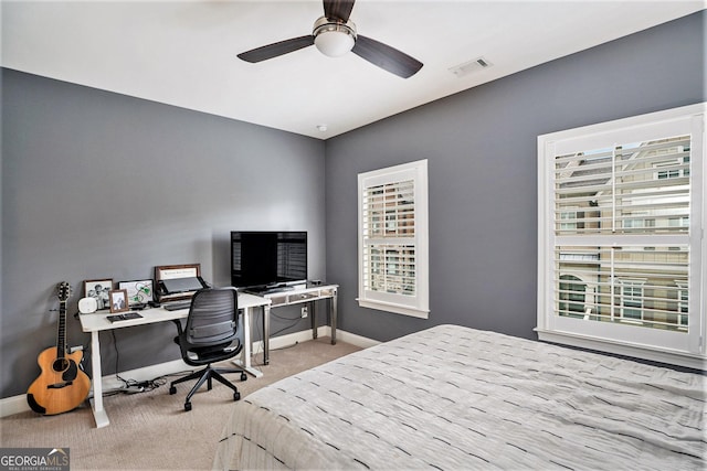 bedroom featuring a ceiling fan, carpet, visible vents, and baseboards