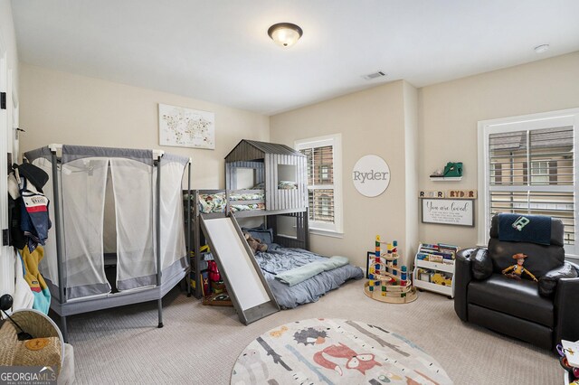 bedroom with light colored carpet