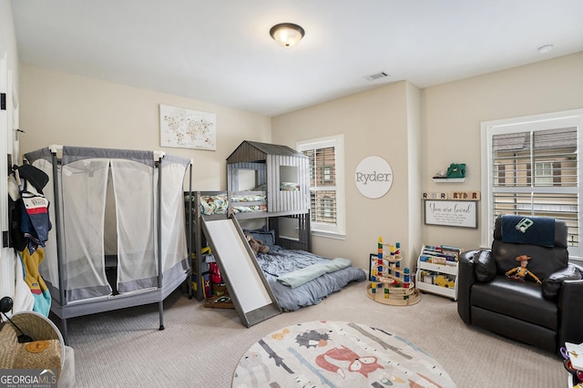 carpeted bedroom with visible vents