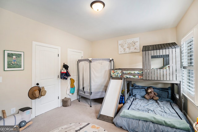 bedroom featuring light carpet and multiple windows