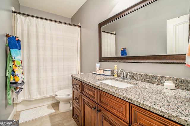 full bathroom featuring tile patterned flooring, vanity, toilet, and shower / bath combo with shower curtain