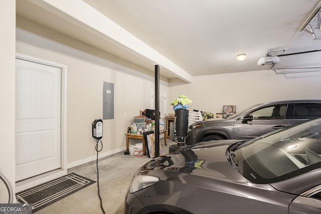 garage featuring electric panel, baseboards, and a garage door opener