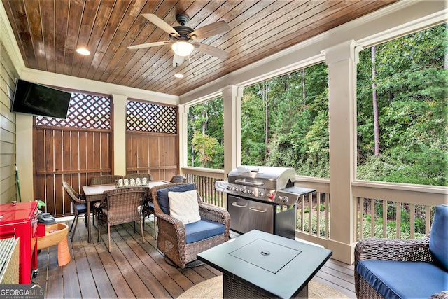 wooden terrace with grilling area and ceiling fan